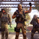 Three operators stand on a bridge carrying guns and other very serious gear.